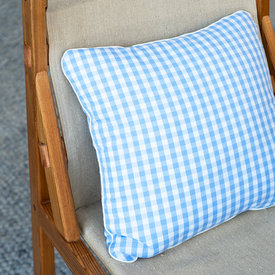 blue gingham cushion on a canvas chair