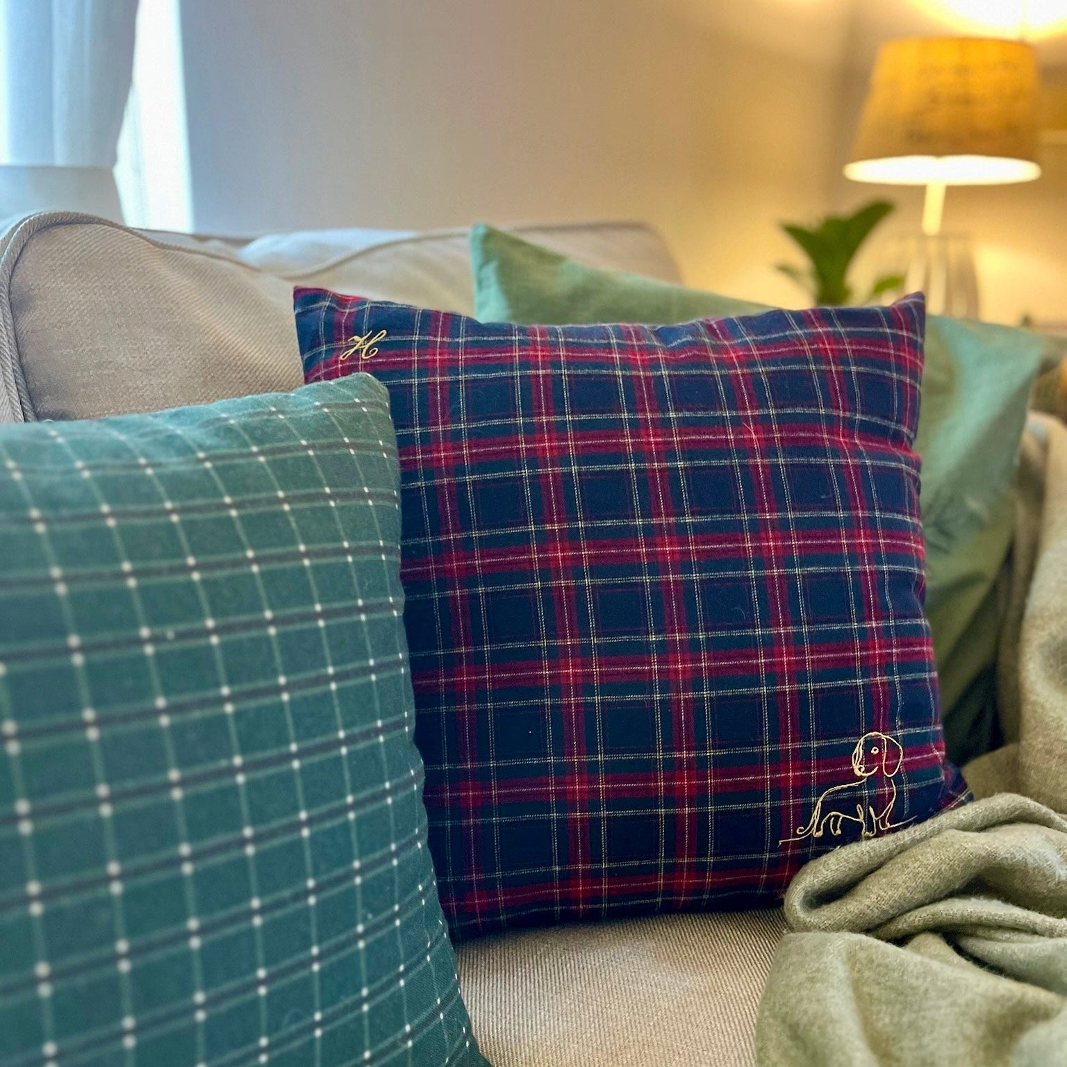 plaid dog cushions on a sofa