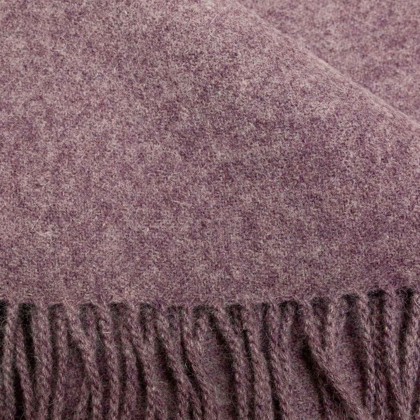 Close-up of a textured purple fabric with fringed edge
