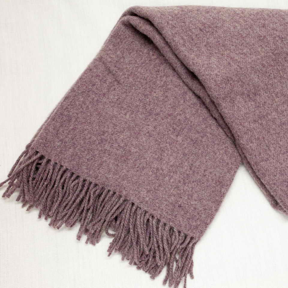 Purple merino wool throw with fringes on a white background