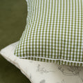 green gingham cushion on a green sofa