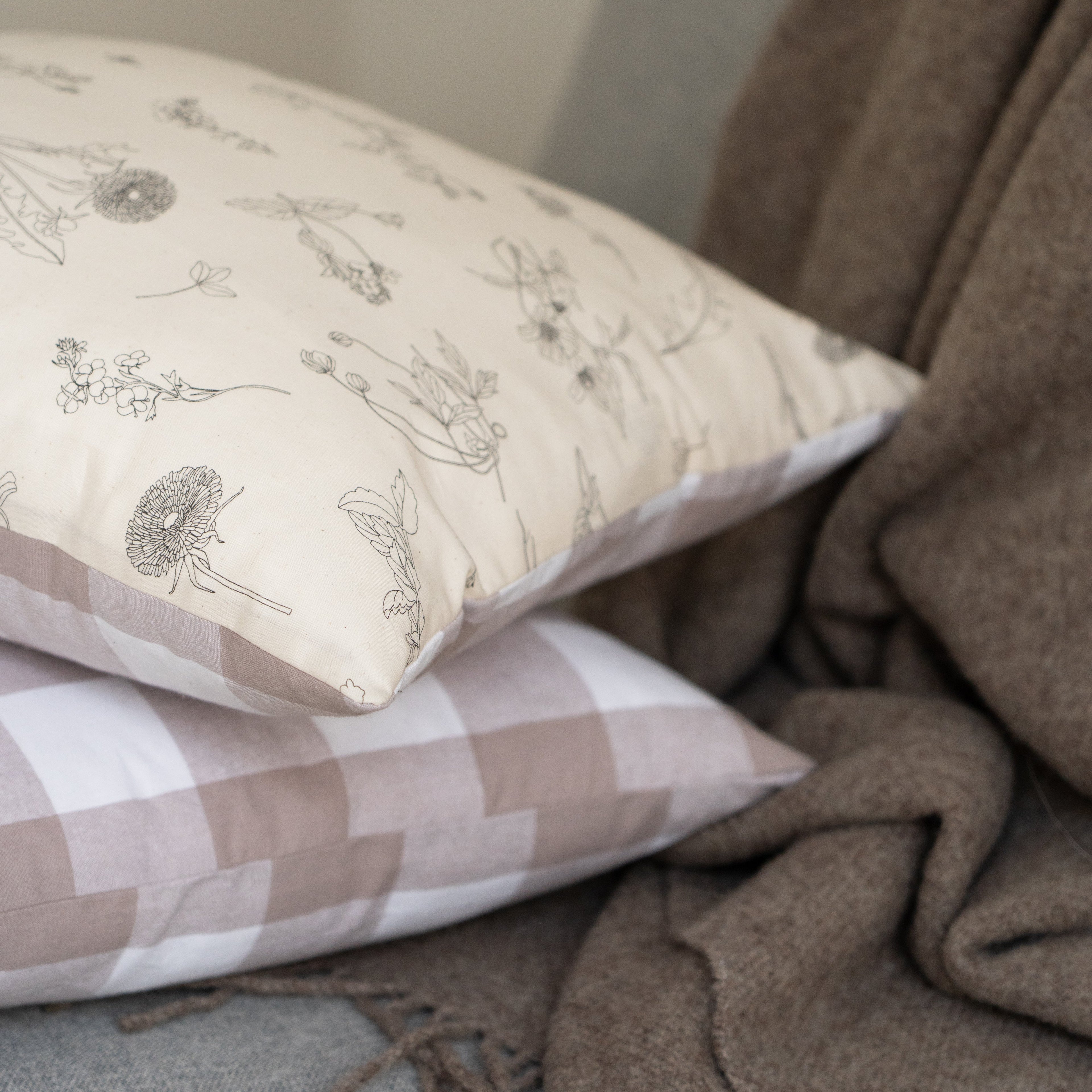 floral cushion on a beige throw