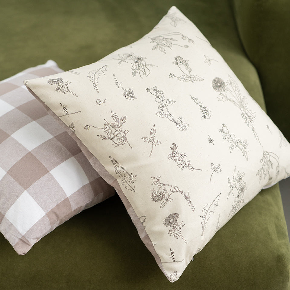 floral cushion on a green sofa